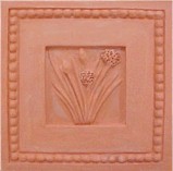 handmade terra cotta ceramic tile with a shell design and a clear gloss or matte glaze