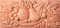 handmade terra cotta ceramic tile with a high relief design and a one color glaze