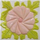 handmade ceramic tile with a high relief flower design and a multi-colored glaze