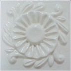 handmade ceramic tile with a high relief design and a multi-colored glaze