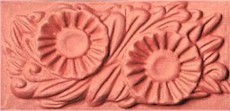 handmade terra cotta ceramic tile with a high relief flower design and a clear gloss or matte glaze