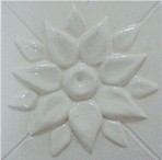 handmade ceramic tile with a high relief flower design and one color glaze