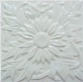 handmade ceramic tile with a high relief flower design and one glaze