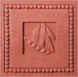 handmade terra cotta ceramic tile with a high relief shell design and a clear matte or gloss glaze