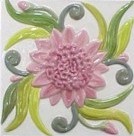 handmade ceramic tile with a high relief flower design and a multi-colored glaze