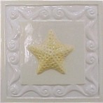 handmade ceramic tile with a high relief shell design and a multi-colored glaze