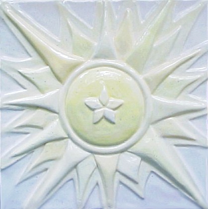 handmade ceramic tile with a high relief graphic design and a  light multi-colored glaze