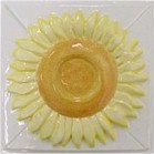 handmade ceramic tile with a high relief flower design and multiple glaze colors