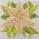 handmade ceramic tile with a high relief flower design and a multi-colored glaze