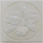 handmade ceramic tile with a high relief flower design and one glaze color