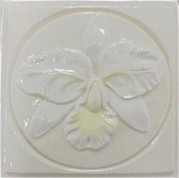 handmade ceramic tile with a high relief design and a multi-colored glaze